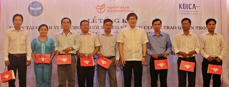 Ông Oh Dea Sik- Chủ tịch Tổ chức Merry Year International tặng quà và chụp ảnh lưu niệm cùng chính quyền các xã, phường. 
