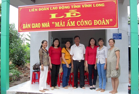 Chị Thanh (người thứ nhì, bên phải) chụp hình lưu niệm trong ngày bàn giao nhà mới.
