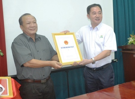 Ông Phạm Thành Khôn (trái)- Trưởng Ban Quản lý Các khu công nghiệp tỉnh trao giấy chứng nhận đăng ký đầu tư cho công ty TNHH New Hope.