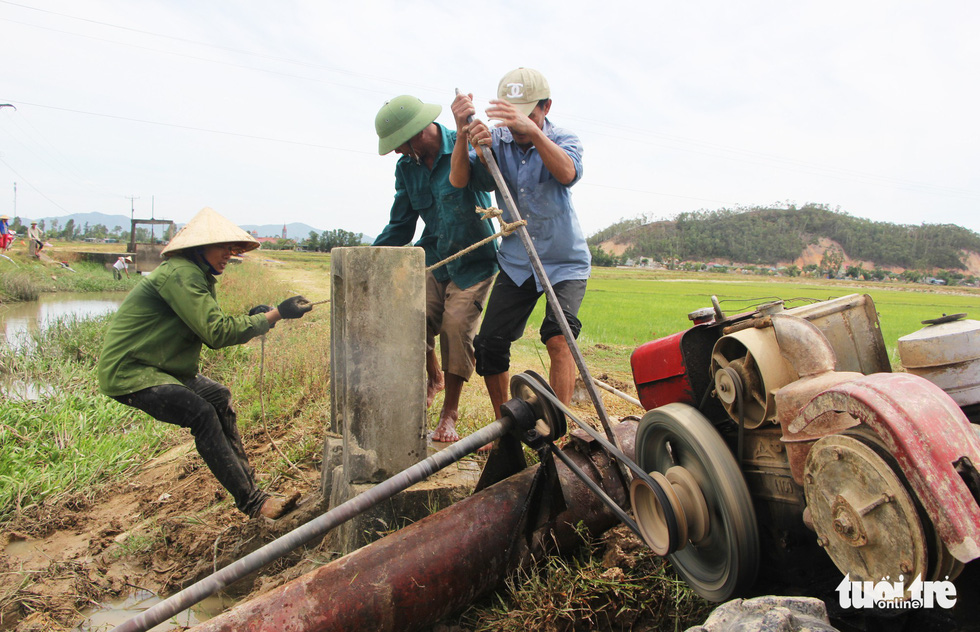 Người dân xã Hưng Yên Nam, huyện Hưng Nguyên, Nghệ An bơm nước cứu lúa khô hạn vào trưa 7/7 - Ảnh: DOÃN HÒA