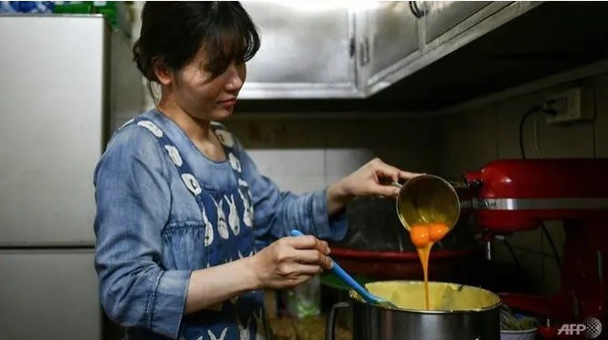 Mỗi sáng chị Giang phải đập 1.000 quả trứng để làm kem phục vụ thực khách. Ảnh: AFP