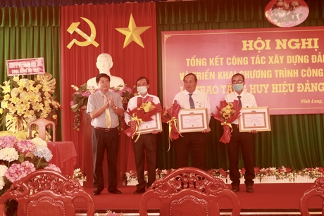 Đồng chí Bùi Văn Nở- Ủy viên Thường vụ Tỉnh ủy, Trưởng Ban Nội chính Tỉnh ủy-  trao huy hiệu Đảng cho các đồng chí cao niên tuổi Đảng.