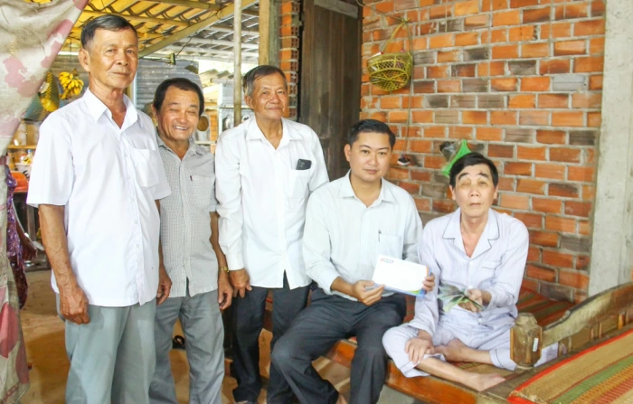 Trao tiền ủng hộ của bạn đọc đến ông Trần Văn Hai